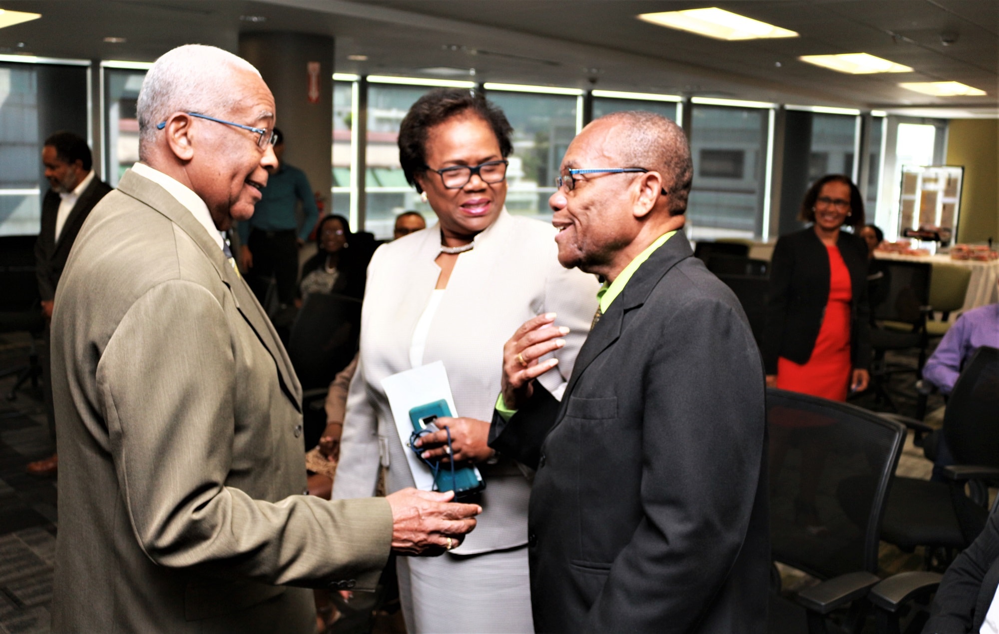 The Hon. Minister Garcia shares a light moment with Prof. Mellowes and Mrs. Lord-Lewis